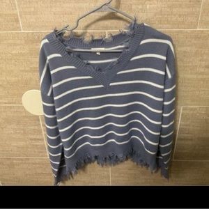 Off the shoulder fringed edge sweater, a lavender purple and white